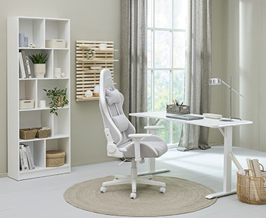 Hvid og beige gamer-stol, hvidt hæve sænkebord og hvid reol