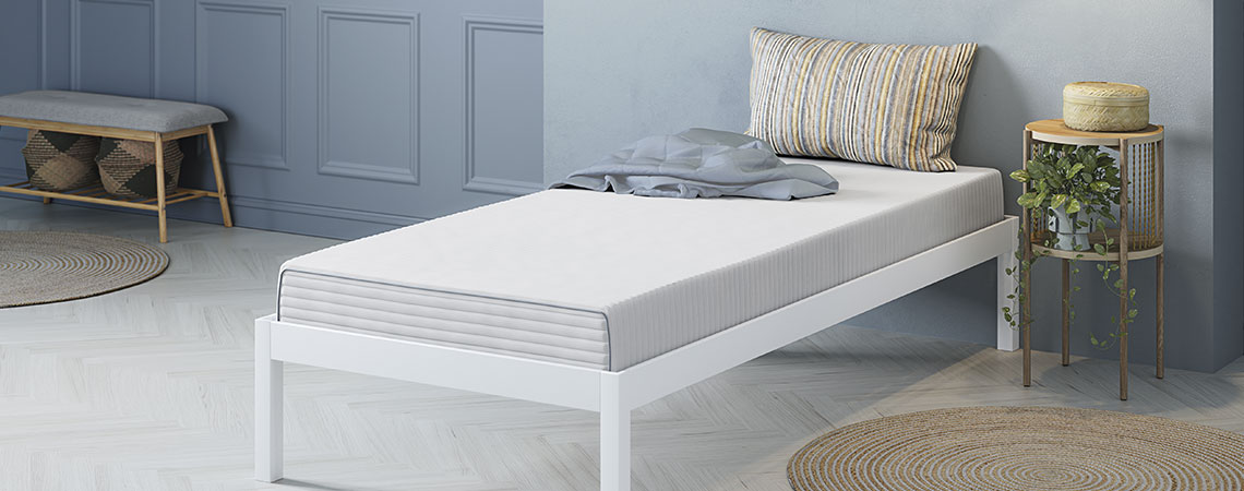 Natural latex mattress in a bed frame in a bedroom