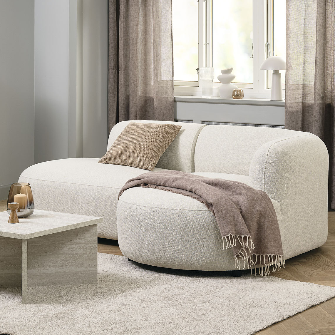 Beige 2-seater sofa with round and organic shapes