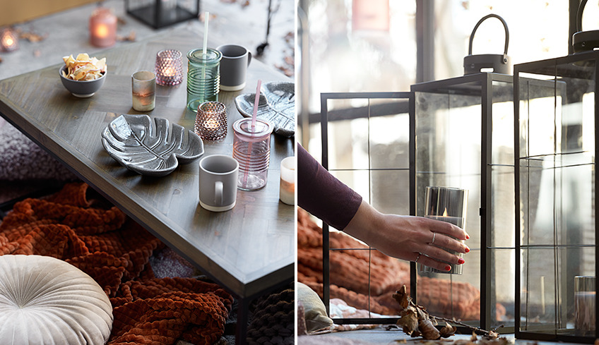 Hyggeligt bord med snacks, glas og fyrfadslys og lanterner med stearinlys i vindue Hyggeligt bord med snacks, glas og fyrfadslys og lanterner med stearinlys i vindue
