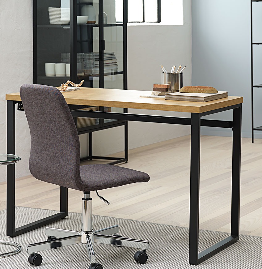 Skrivebord med sorte metalben og grå kontorstol