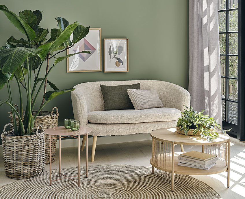 Stue med hvid sofa, sofabord i egetræ og grønne planter